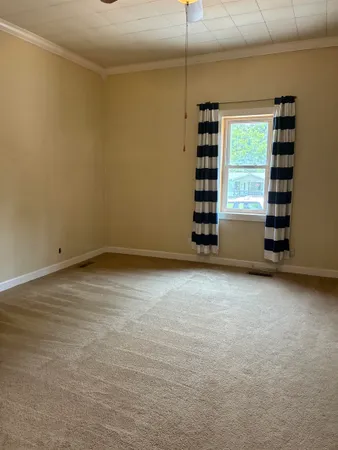 a bedroom with a bed and a potted plant