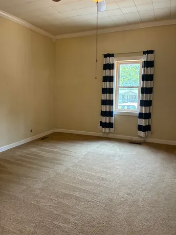a bedroom with a bed and a potted plant