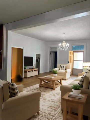 a living room with furniture and a flat screen tv