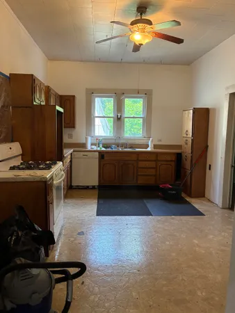 a kitchen with stainless steel appliances granite countertop a stove refrigerator and microwave