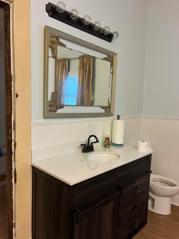 a view of a chandelier fan and wooden floor