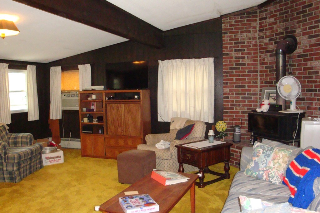 379 Townsend Harbor Road Lunenburg, MA 01462 - Photo 12 of 21 a living room with furniture and a flat screen tv