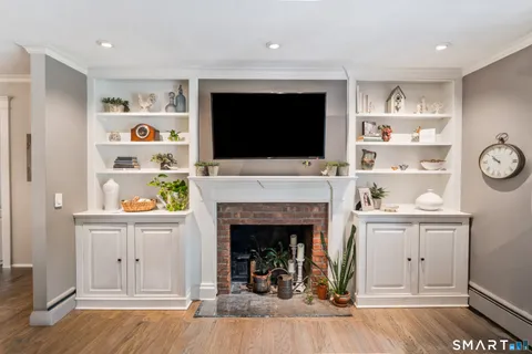 a living room with a fireplace and a flat screen tv