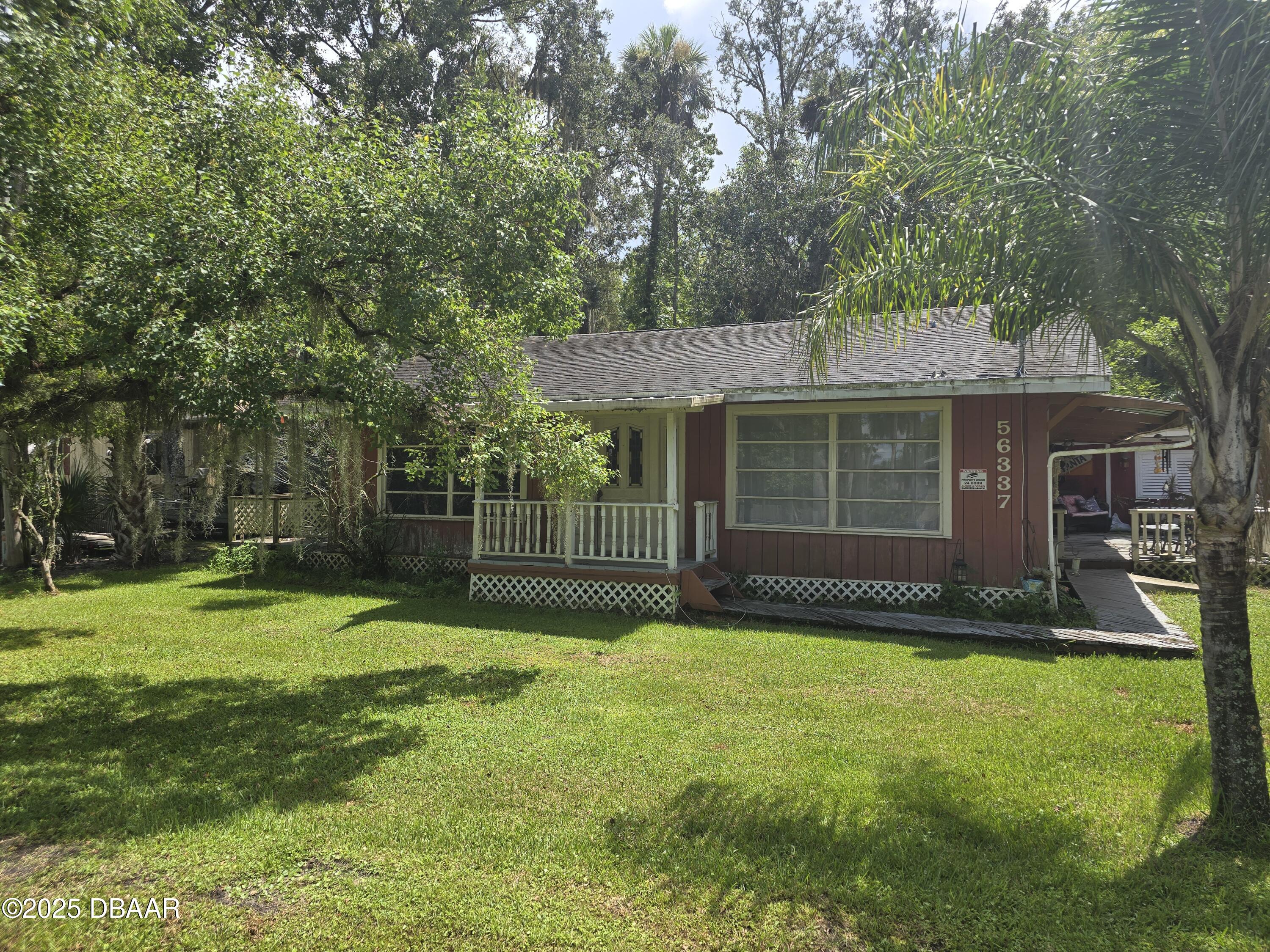 56337 Blue Creek Road Astor, FL 32102 - Photo 22 of 22 a view of a house with a yard and sitting area