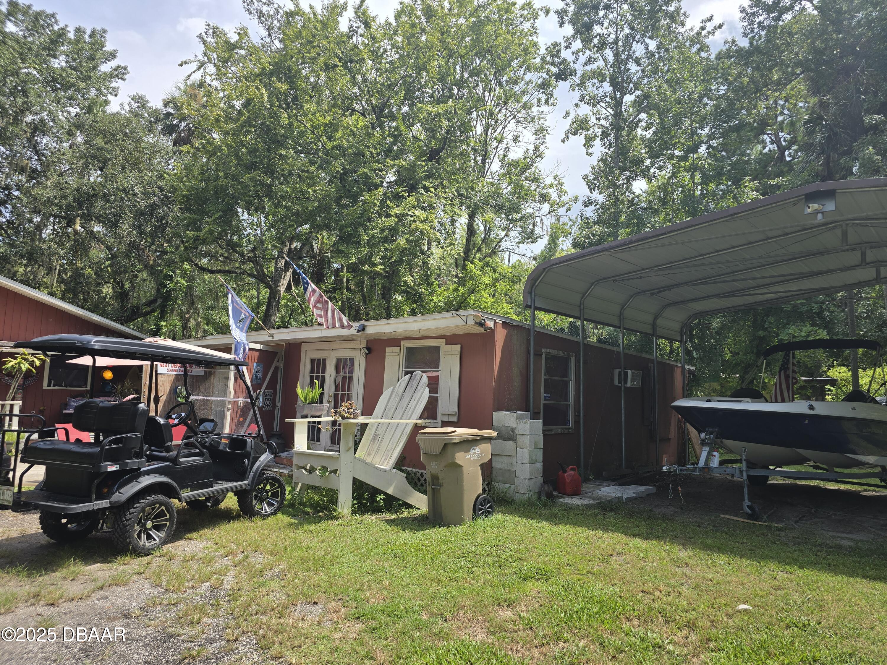 56337 Blue Creek Road Astor, FL 32102 - Photo 4 of 22 a view of a backyard with a patio and a slide