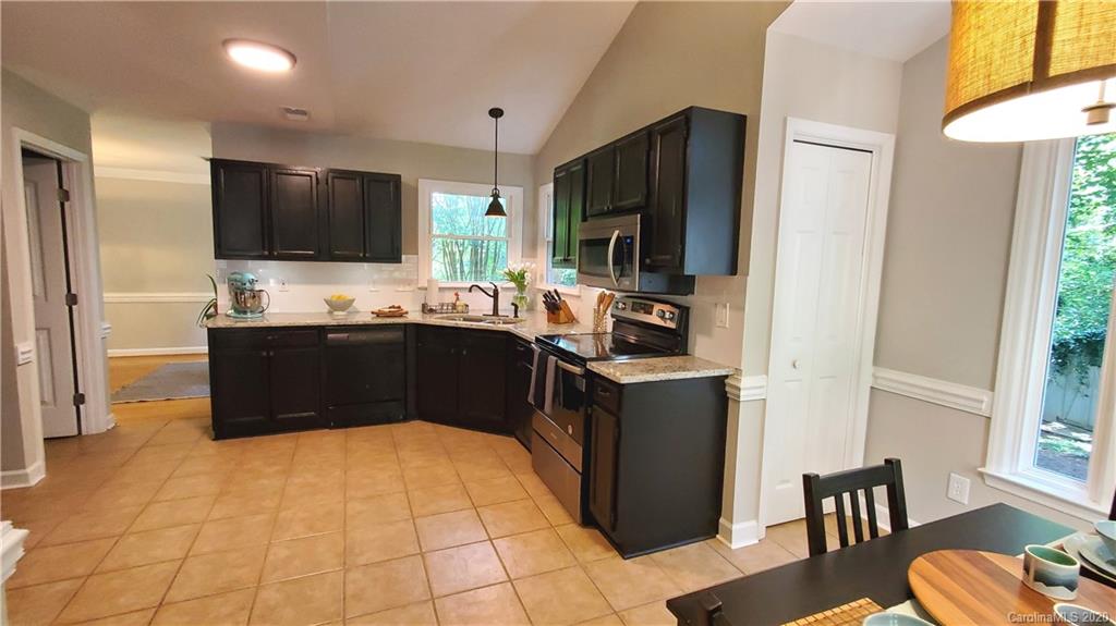 20700 Willow Pond Road Cornelius, NC 28031 - Photo 11 of 47 a kitchen with stainless steel appliances a sink stove and refrigerator