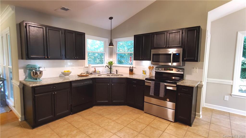20700 Willow Pond Road Cornelius, NC 28031 - Photo 15 of 47 a kitchen with a sink stove and refrigerator