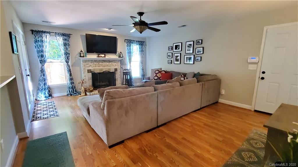 20700 Willow Pond Road Cornelius, NC 28031 - Photo 21 of 47 a living room with furniture a flat screen tv and a fireplace