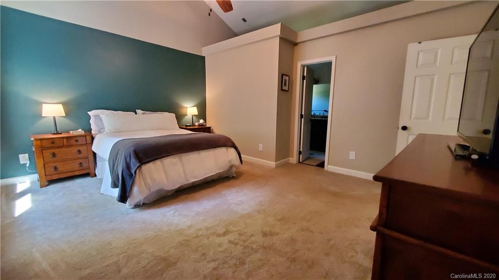 20700 Willow Pond Road Cornelius, NC 28031 - Photo 29 of 47 a spacious bedroom with a bed and a lamp