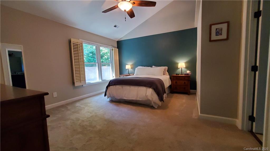 20700 Willow Pond Road Cornelius, NC 28031 - Photo 31 of 47 a bedroom with a bed and a chandelier