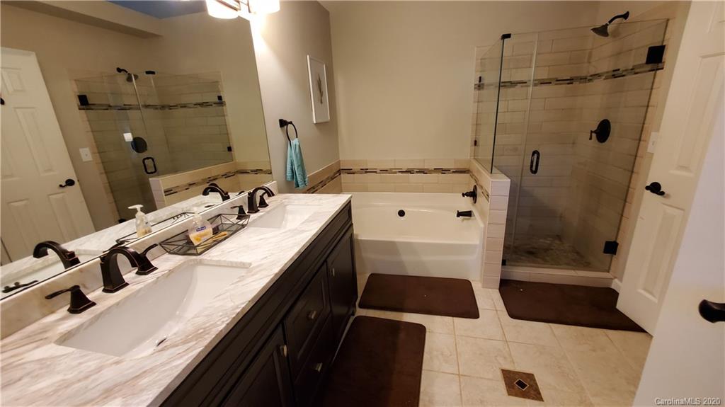 20700 Willow Pond Road Cornelius, NC 28031 - Photo 34 of 47 a bathroom with a sink a toilet and shower