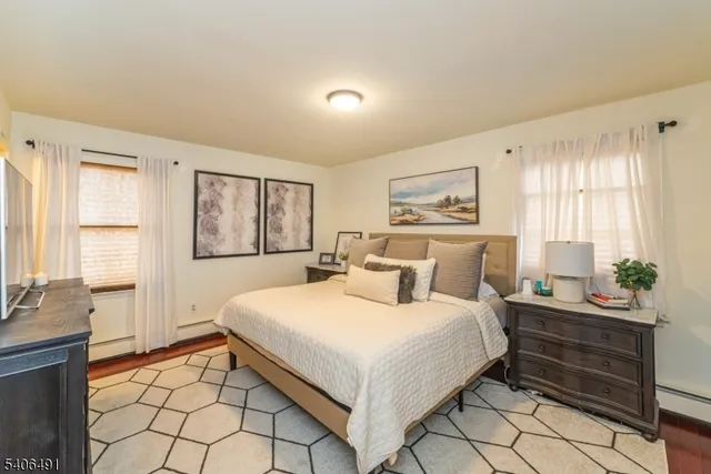 a bedroom with a large bed and a window