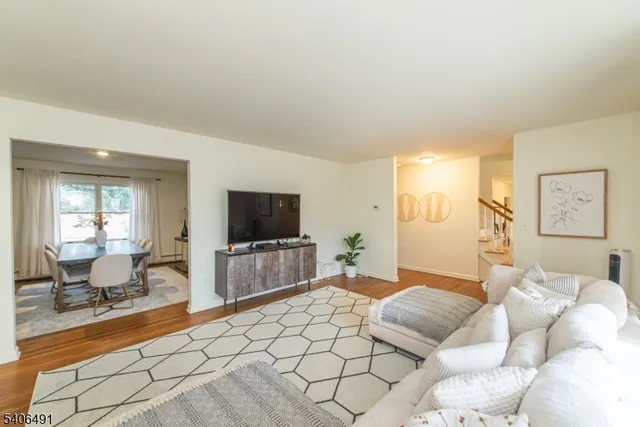 a bedroom with furniture and a flat screen tv