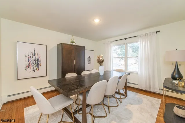 a view of a dining room with furniture and a window