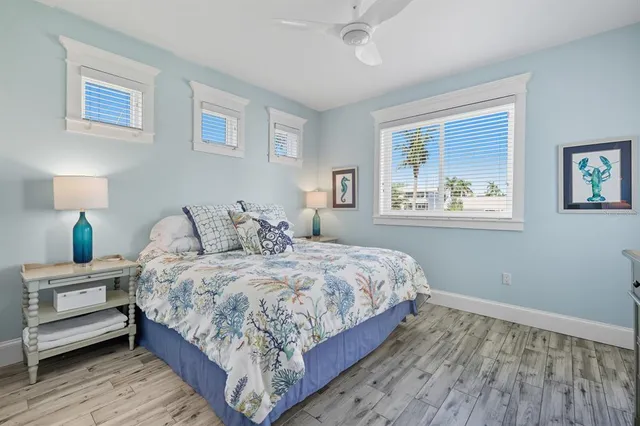 a living room with furniture a flat screen tv and a floor to ceiling window