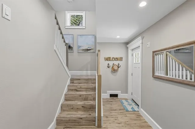 a living room with furniture flat screen tv and a large window