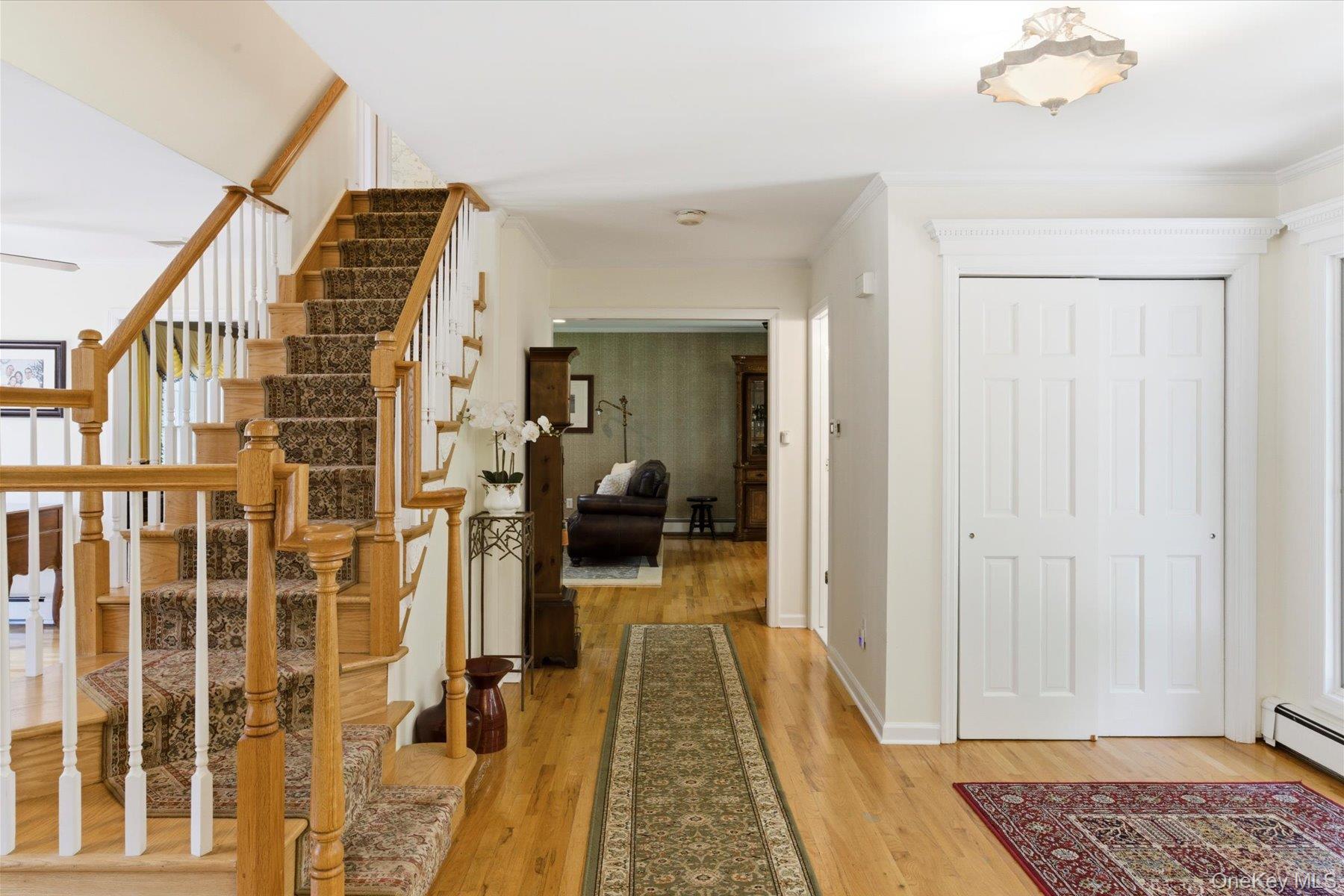 6 Brandy Road Cold Spring Harbor, NY 11724 - Photo 3 of 25 a view of a hallway with wooden floor and a living room