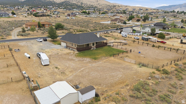 2567 West Rim Rock Drive Stockton, UT 84071 - Photo 63 of 64 Ranch-style residence featuring a covered front porch, an attached garage, and a fenced perimeter