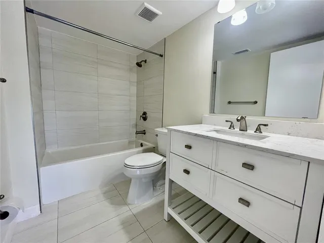 a bathroom with a double vanity sink toilet and shower