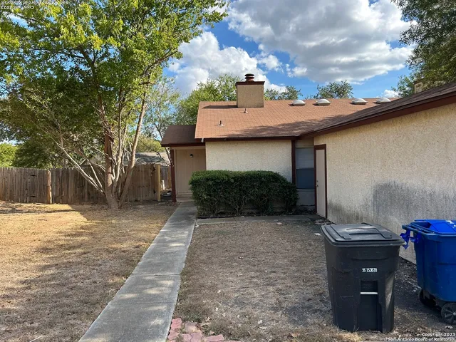 a view of a backyard with sitting area
