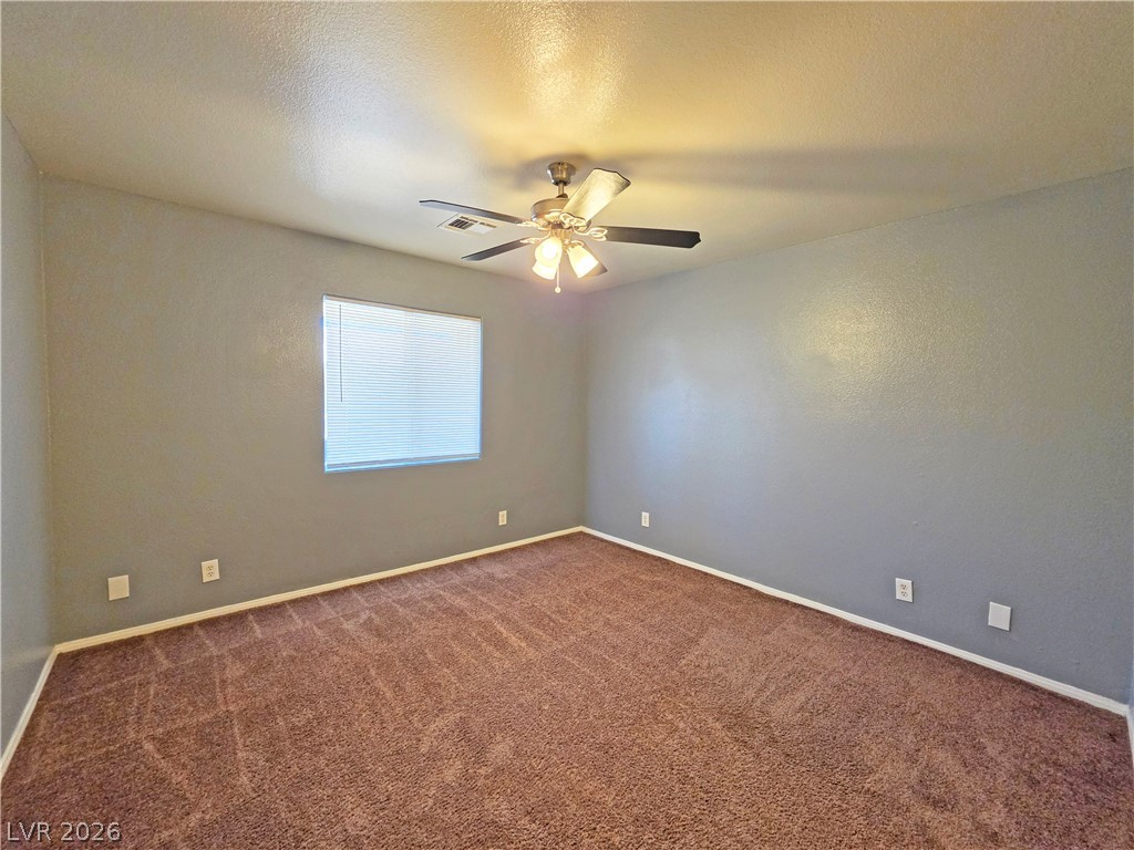 1444 Star Road, Unit 3 Pahrump, NV 89048 - Photo 28 of 35 Well-appointed with a ceiling fan and natural light, this bedroom provides comfort.