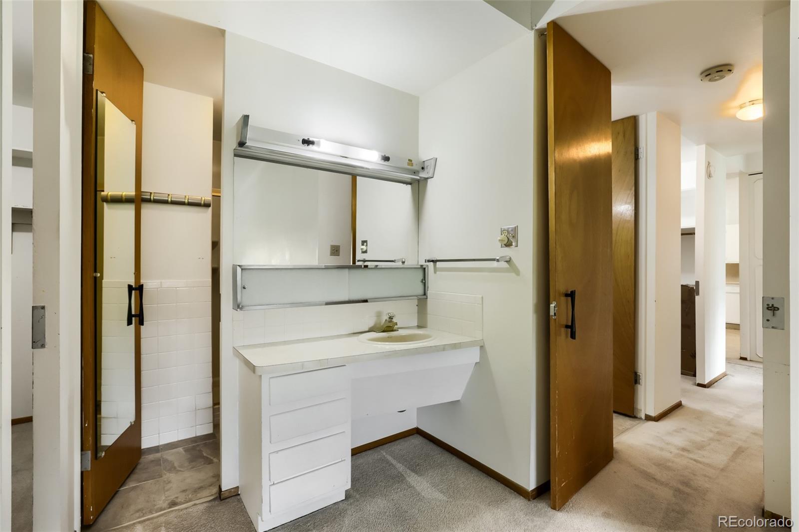 625 South Clinton Street, Unit 7B Denver, CO 80247 - Photo 11 of 22 a bathroom with a sink a mirror and shower