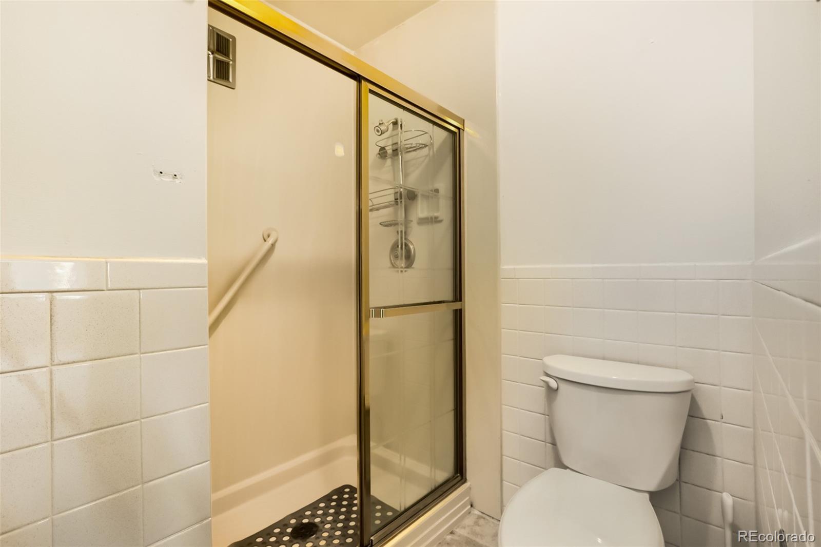 625 South Clinton Street, Unit 7B Denver, CO 80247 - Photo 12 of 22 a bathroom with a toilet and a shower