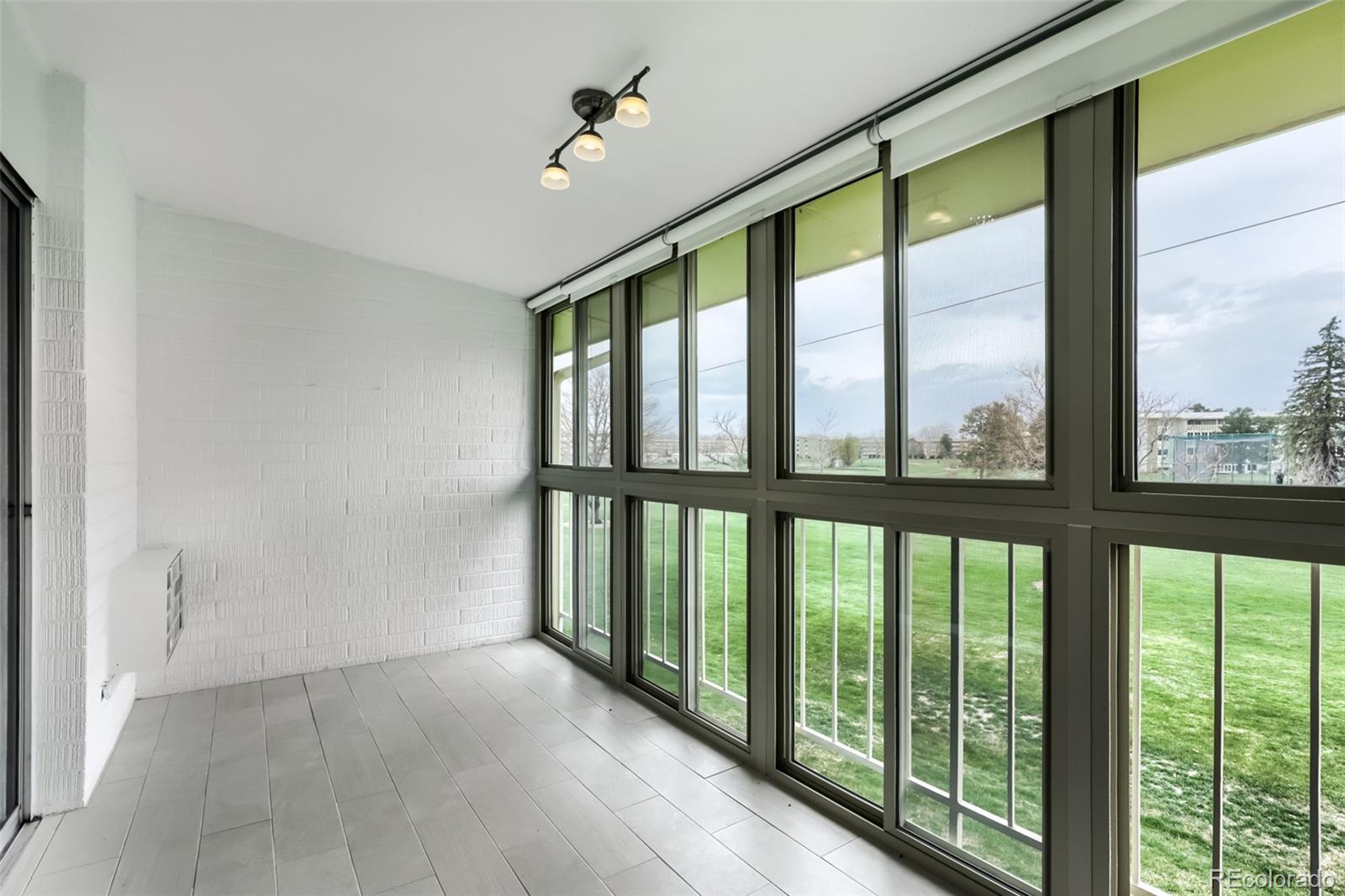 625 South Clinton Street, Unit 7B Denver, CO 80247 - Photo 7 of 22 a view of an empty room with windows