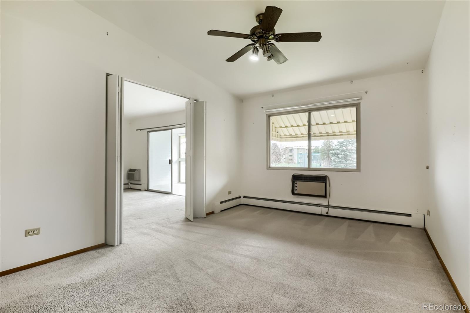 625 South Clinton Street, Unit 7B Denver, CO 80247 - Photo 8 of 22 an empty room with fan and windows