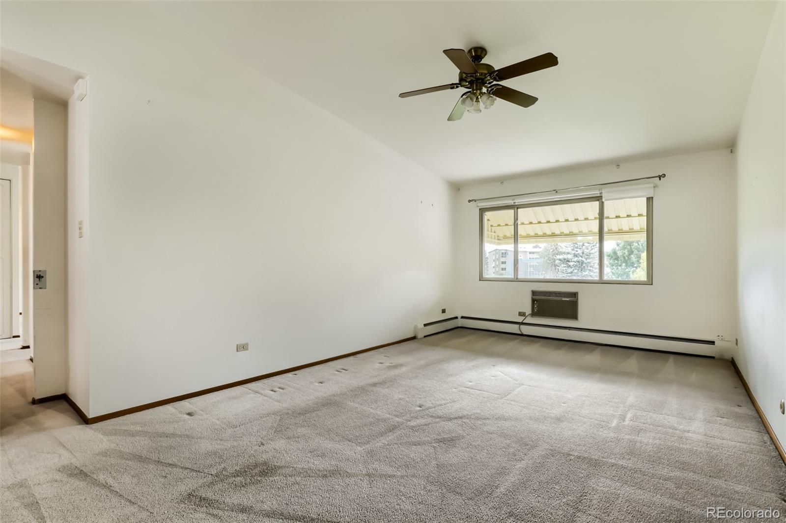 625 South Clinton Street, Unit 7B Denver, CO 80247 - Photo 9 of 22 an empty room with windows and fan