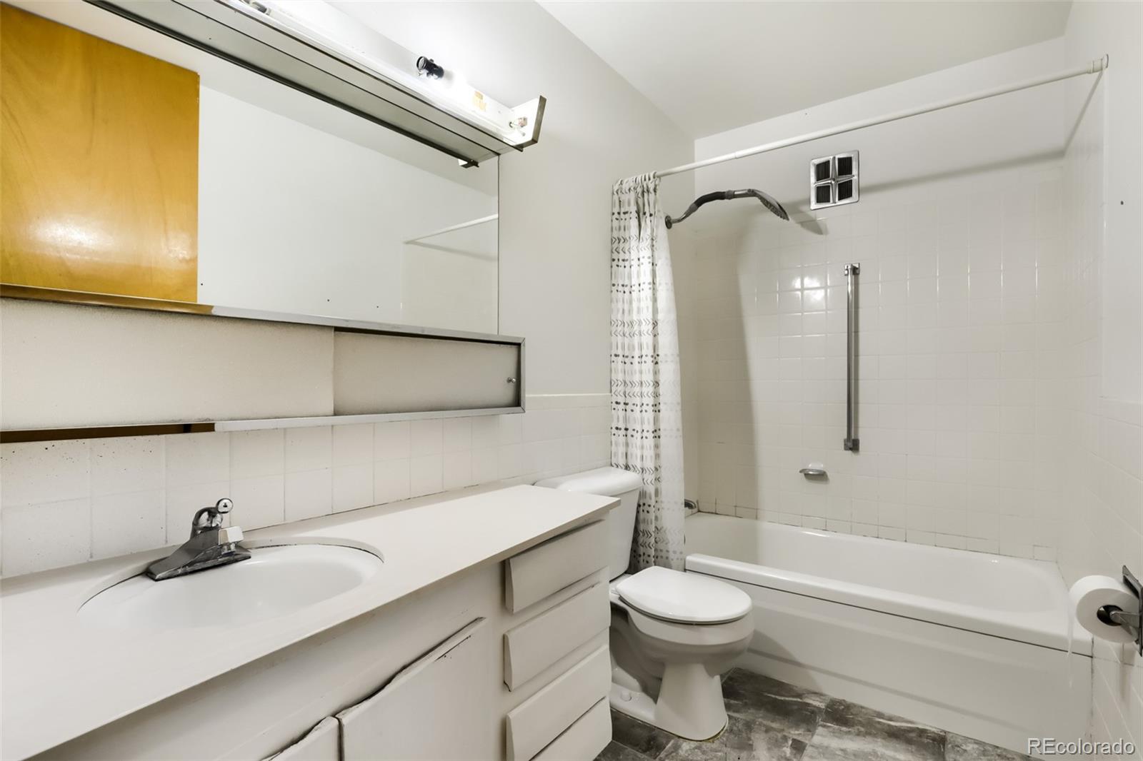 625 South Clinton Street, Unit 7B Denver, CO 80247 - Photo 10 of 22 a bathroom with a sink a toilet and shower