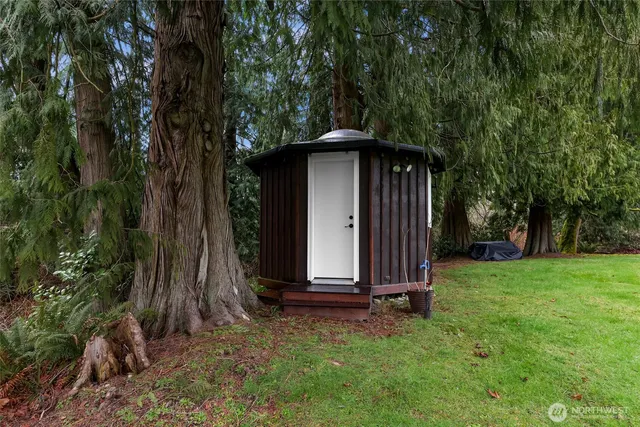 a view of a room that has a window and wooden floor