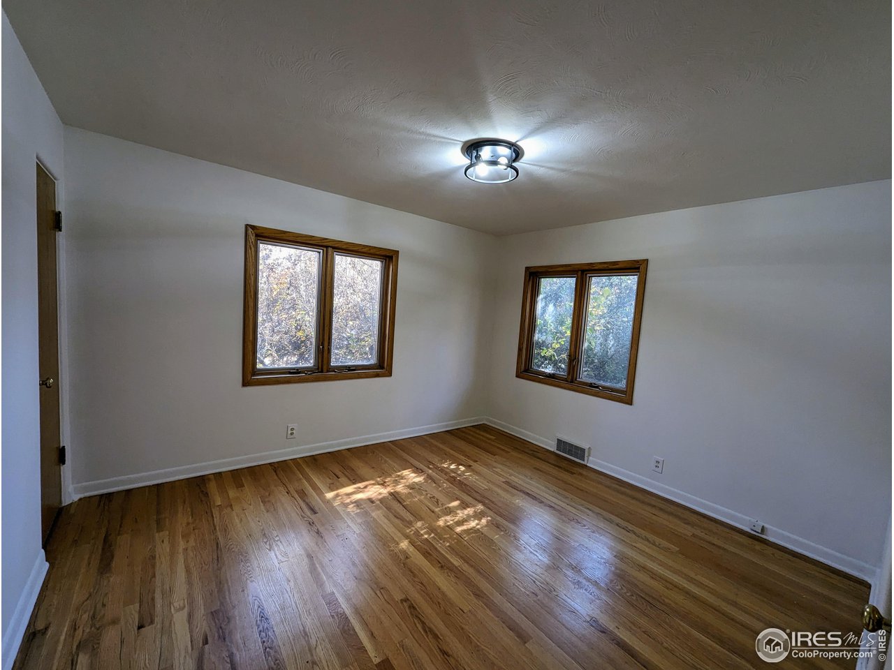 1951 Vista Drive Boulder, CO 80304 - Photo 12 of 35 wooden floor in an empty room with a window