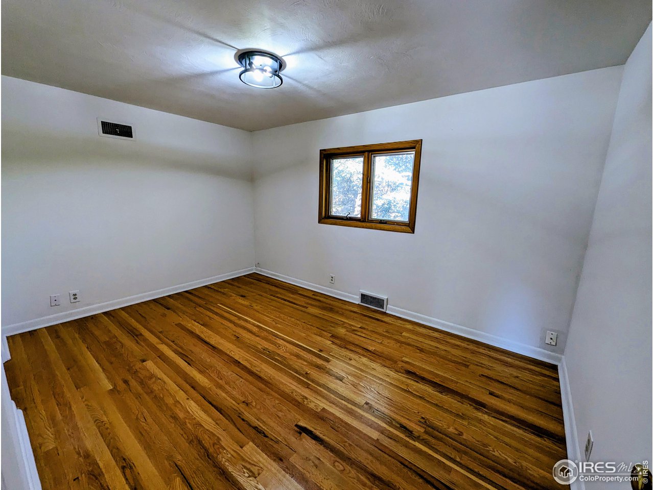 1951 Vista Drive Boulder, CO 80304 - Photo 13 of 35 a view of empty room with wooden floor