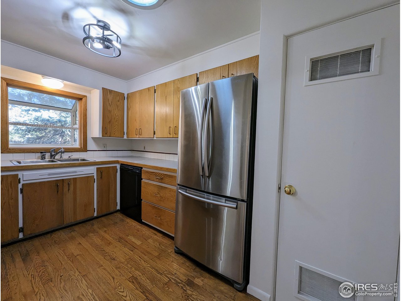1951 Vista Drive Boulder, CO 80304 - Photo 8 of 35 a kitchen with granite countertop stainless steel appliances a refrigerator cabinets and wooden floor