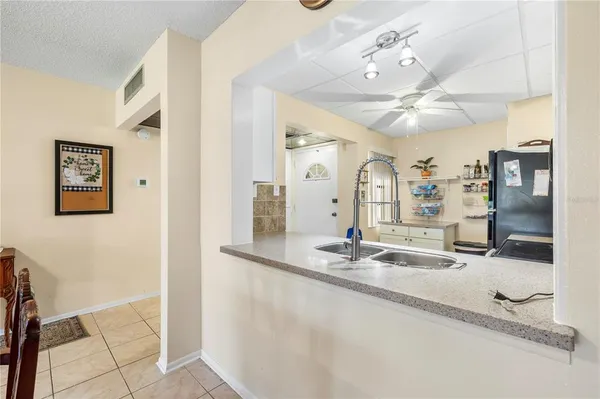 a view of a living room and kitchen with granite countertop