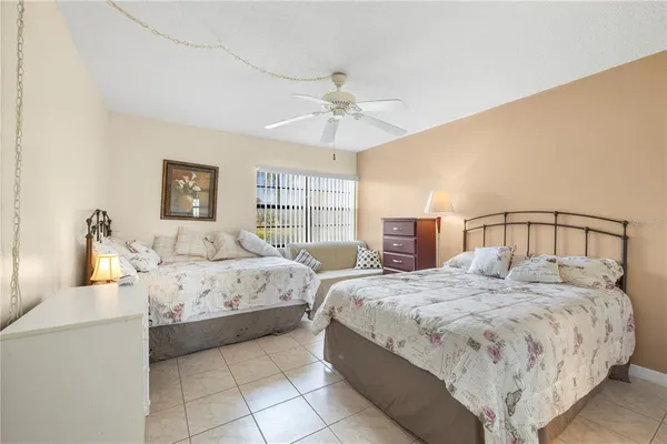 a bedroom with bed and a chandelier