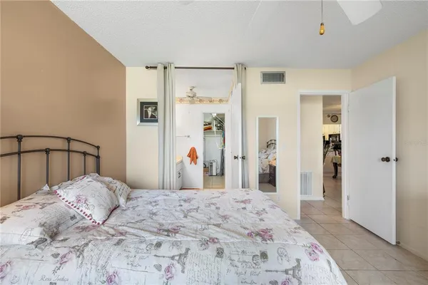a bedroom with a large bed and a dresser