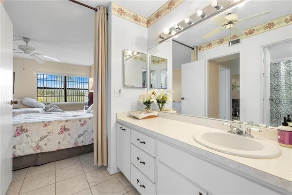a spacious bathroom with a double vanity sink mirror and bathtub