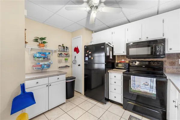 a kitchen with stainless steel appliances a refrigerator a stove a microwave oven cabinets and a counter top space