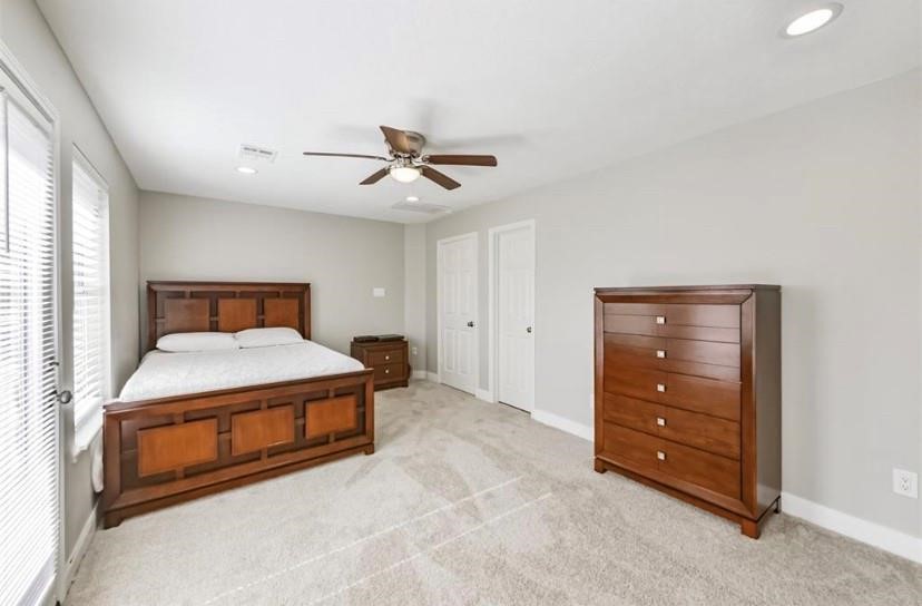 8002 Harbor Point Drive Houston, TX 77071 - Photo 16 of 25 a bedroom with a bed and a ceiling fan