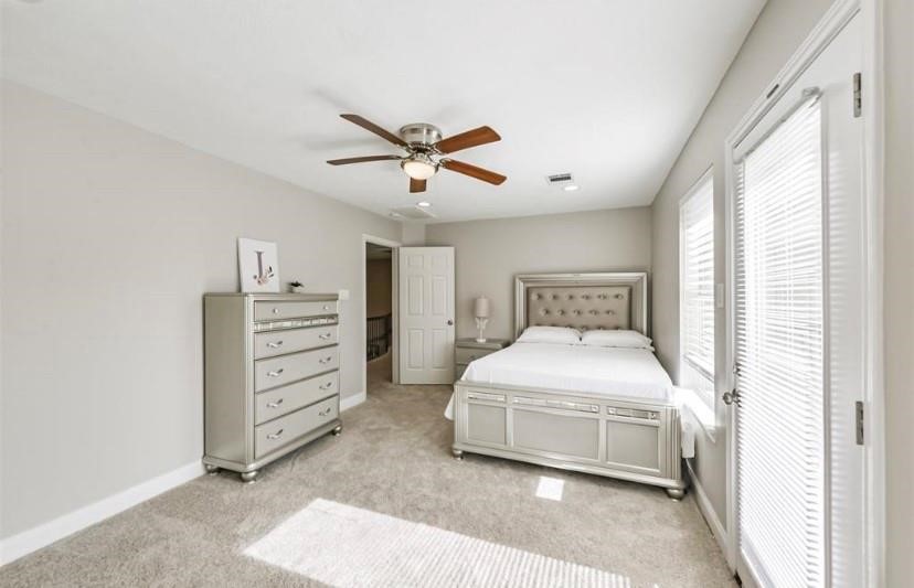 8002 Harbor Point Drive Houston, TX 77071 - Photo 20 of 25 a bedroom with a bed and a ceiling fan