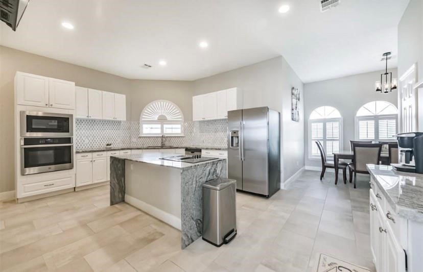 8002 Harbor Point Drive Houston, TX 77071 - Photo 21 of 25 a kitchen with stainless steel appliances granite countertop a stove refrigerator and a sink