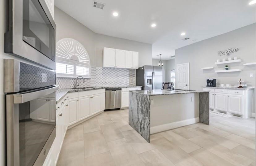 8002 Harbor Point Drive Houston, TX 77071 - Photo 22 of 25 a kitchen with white cabinets and white appliances