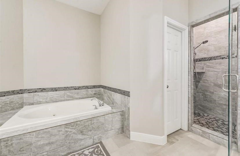8002 Harbor Point Drive Houston, TX 77071 - Photo 8 of 25 a bathroom with a bathtub and a shower