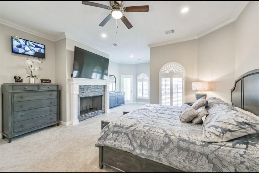 8002 Harbor Point Drive Houston, TX 77071 - Photo 10 of 25 a bedroom with a large bed and a fireplace
