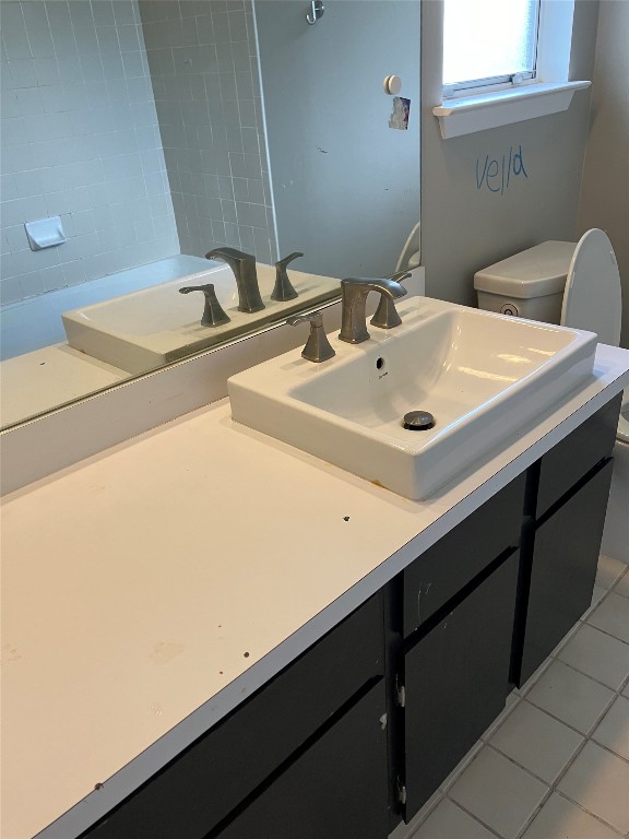 7700 Copperas Drive Austin, TX 78749 - Photo 14 of 14 a bathroom with a sink and a toilet