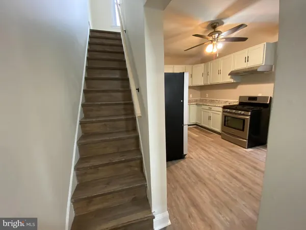 a view of a kitchen with sink and wooden floor