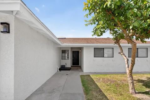 a front view of a house with garden