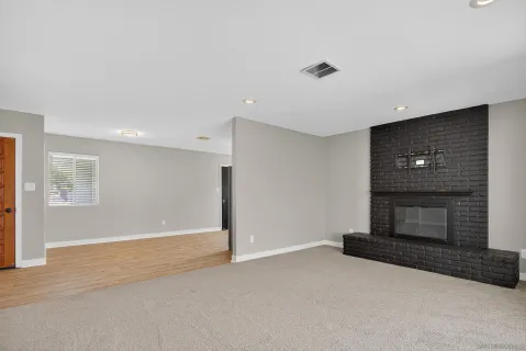 a view of an empty room with a fireplace